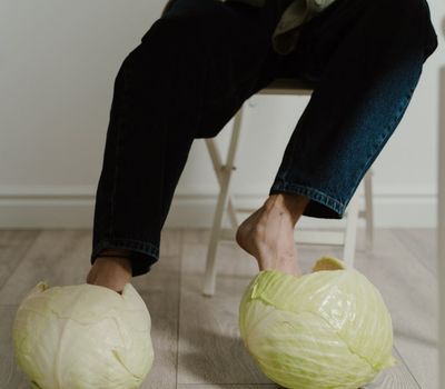 Close-up shot of a person's feet on a wooden floor, suggesting grounding and stability.